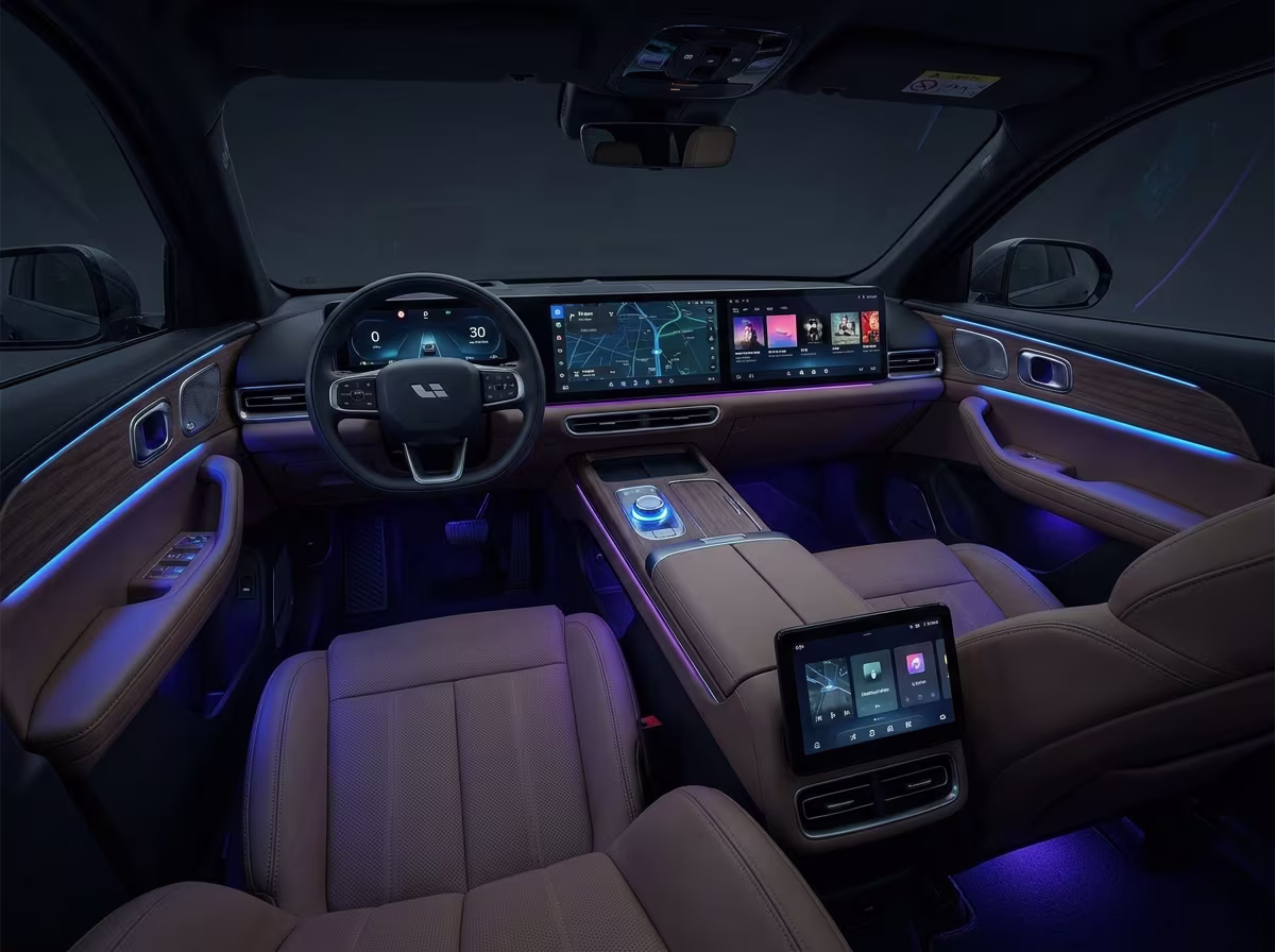 The high-tech futuristic interior of a premium Chinese electric car, featuring dual panoramic touchscreens and ambient lighting.